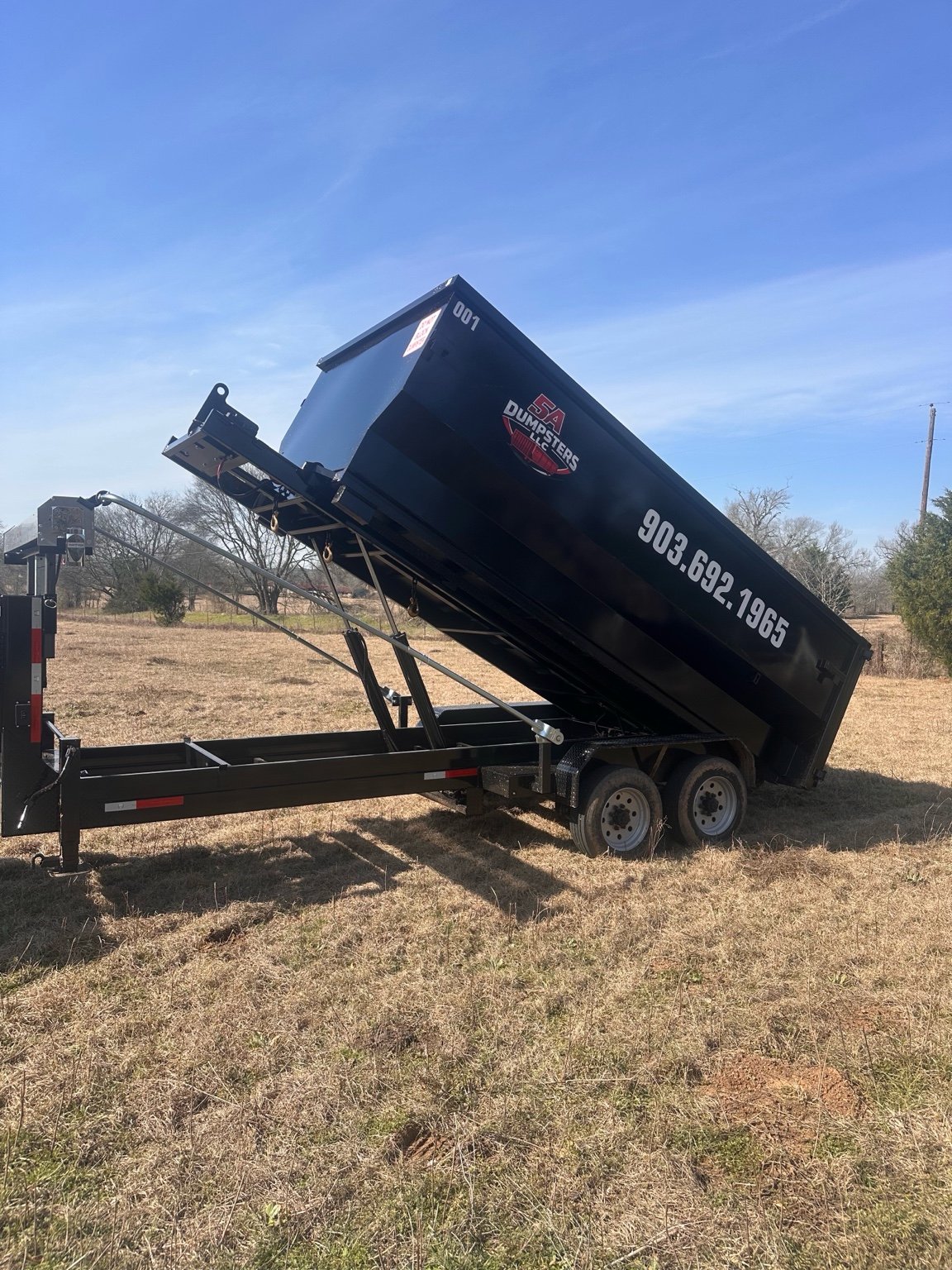 20 yard dumpster unloading on trailer